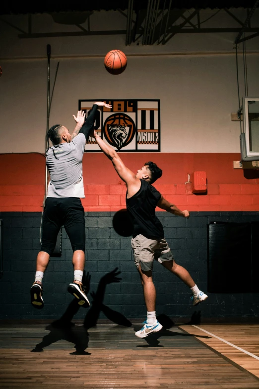 two basketball players jumping for the basket during a game