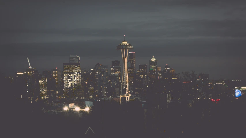 this is the city skyline in front of the seattle skyline at night