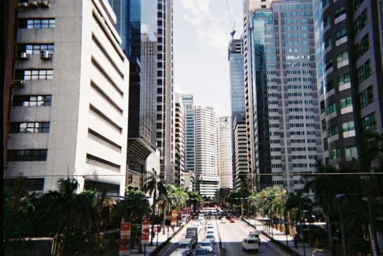 a street lined with tall buildings in the city