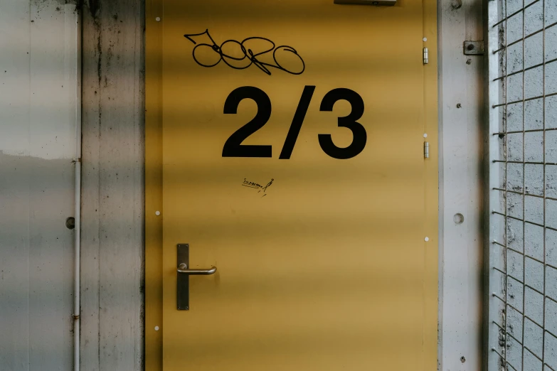 the door is yellow with black numbers on it