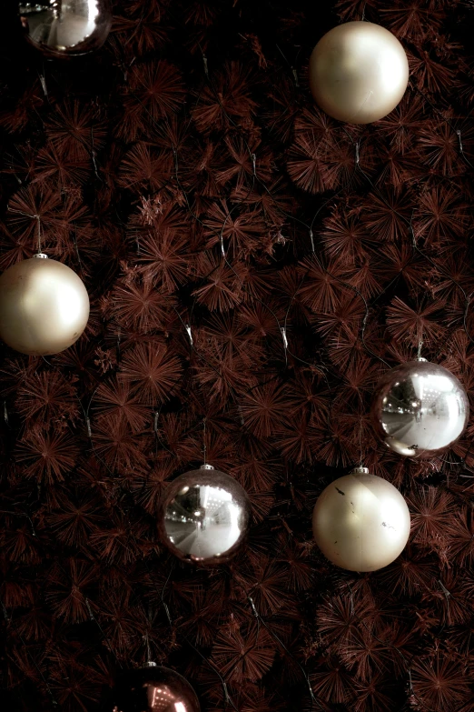 some silver ornaments sitting on brown leather