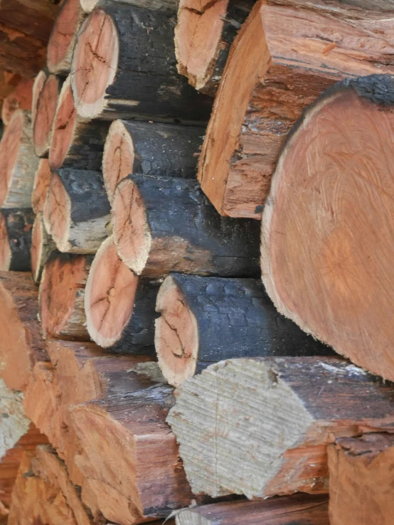 lots of logs have been stacked up with some missing pieces