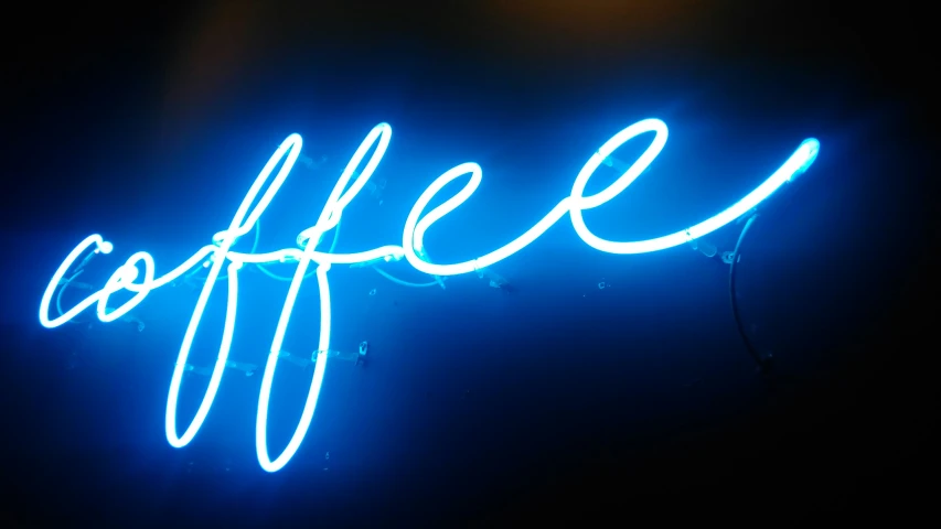 neon coffee sign in the dark blue sky