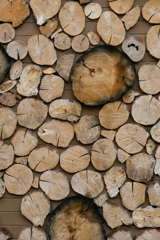 a pile of logs made of wood on a wood deck