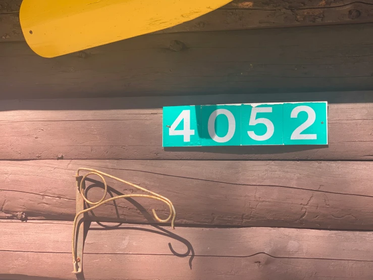 a house number plate that reads 48052 hanging from the wall