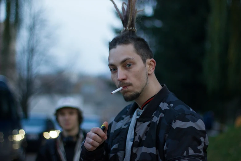 a young man with a funny mohawk smoking a cigarette