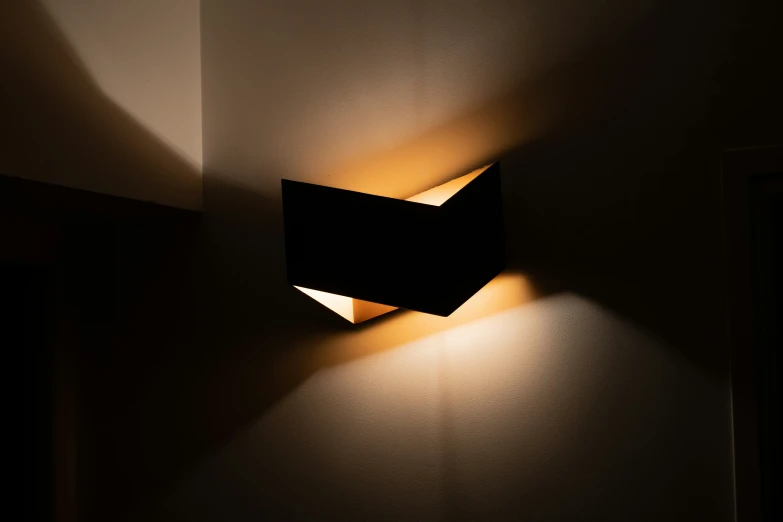 wall light in dark room with shadow