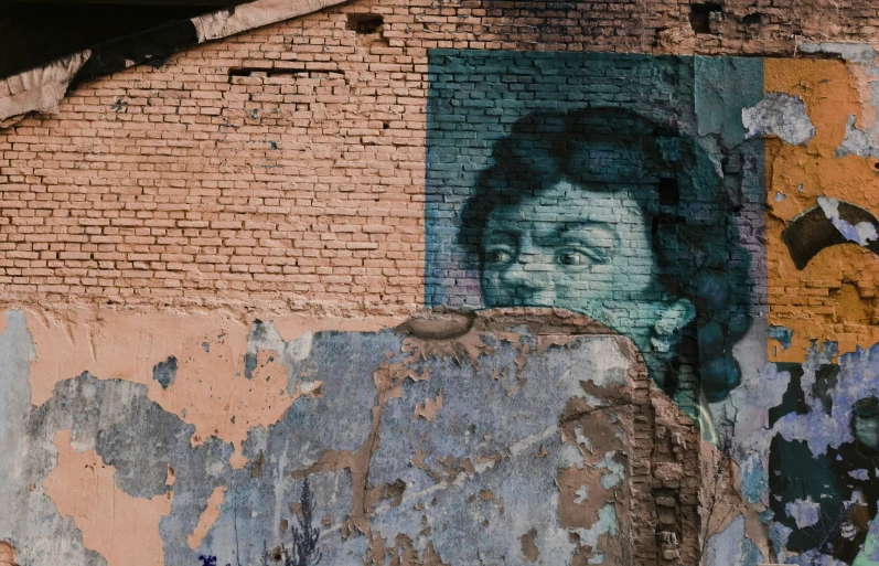 a brick building with a painted picture of a woman and a dog