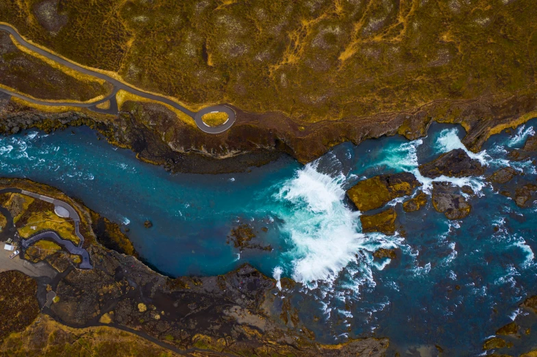 the water is flowing into some dark blue water