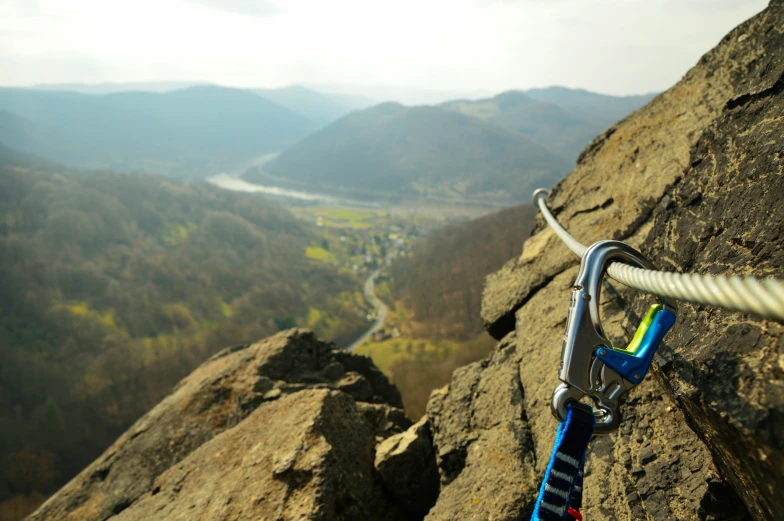 an extreme mountain climbing device is hanging on the edge of a rock