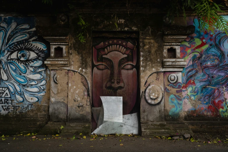 a doorway with graffiti on the walls has a toilet paper next to it