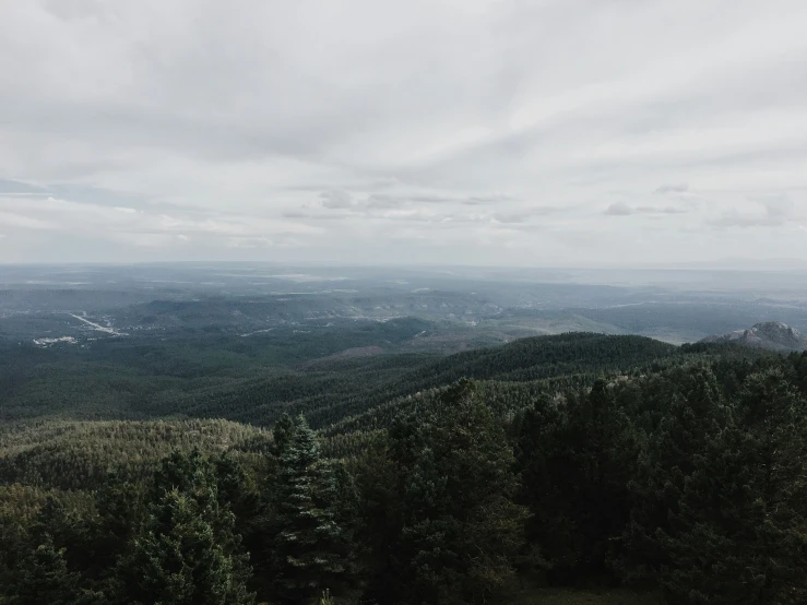 the view from an overlook of green mountains and fields