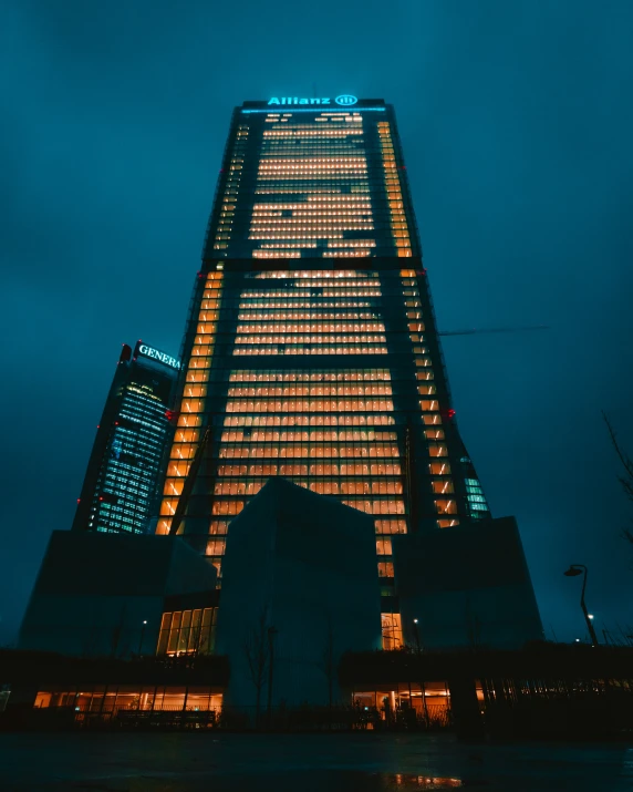a tall building lit up at night with light from the windows
