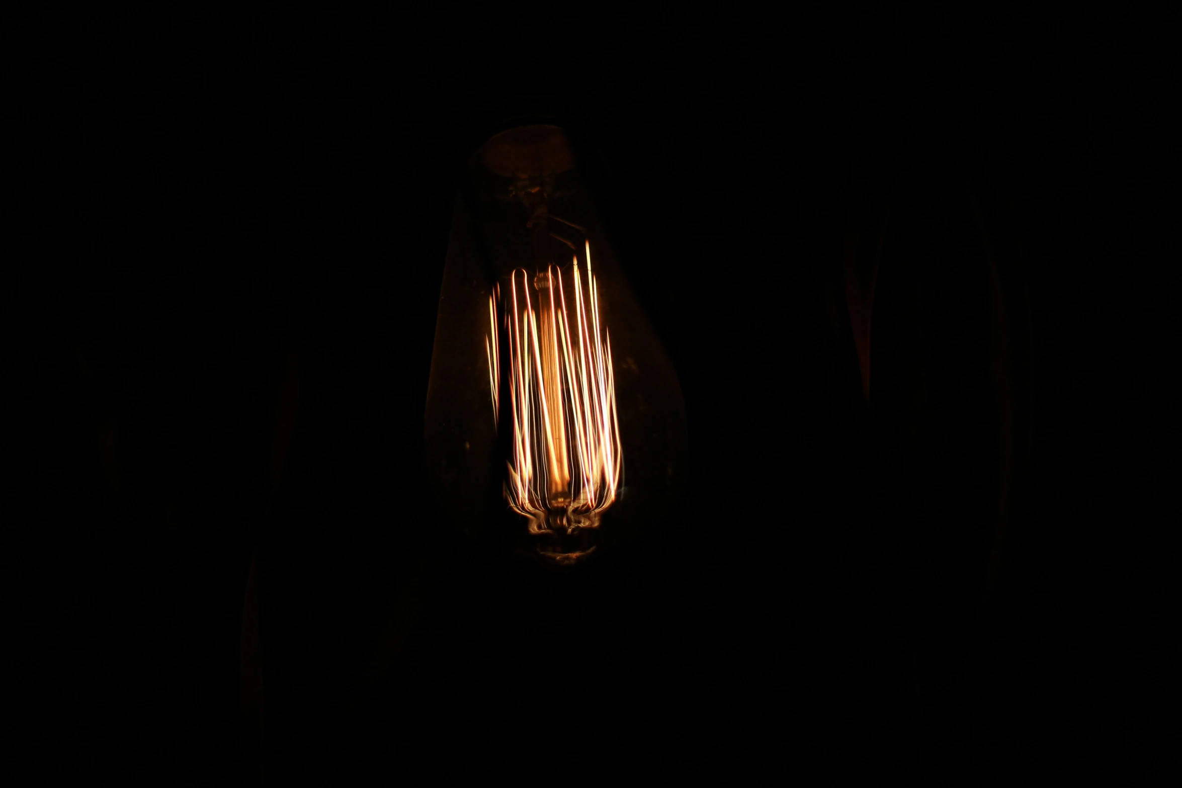 a lighted light bulb with fireworks sticking out of it