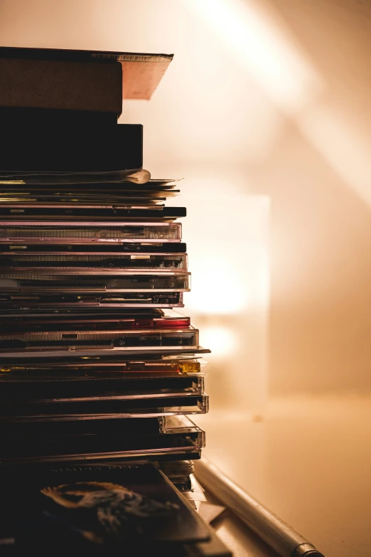 a lamp shines on a stack of books