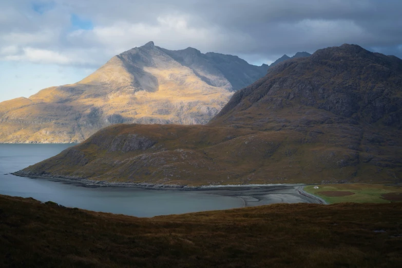 a landscape view with some mountains around the lake