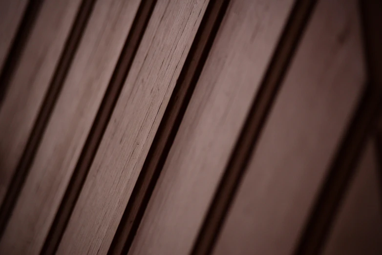 a wood wall with vertical lines sticking up