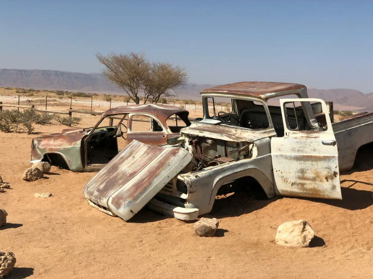 the old and broken out trucks are left in the desert