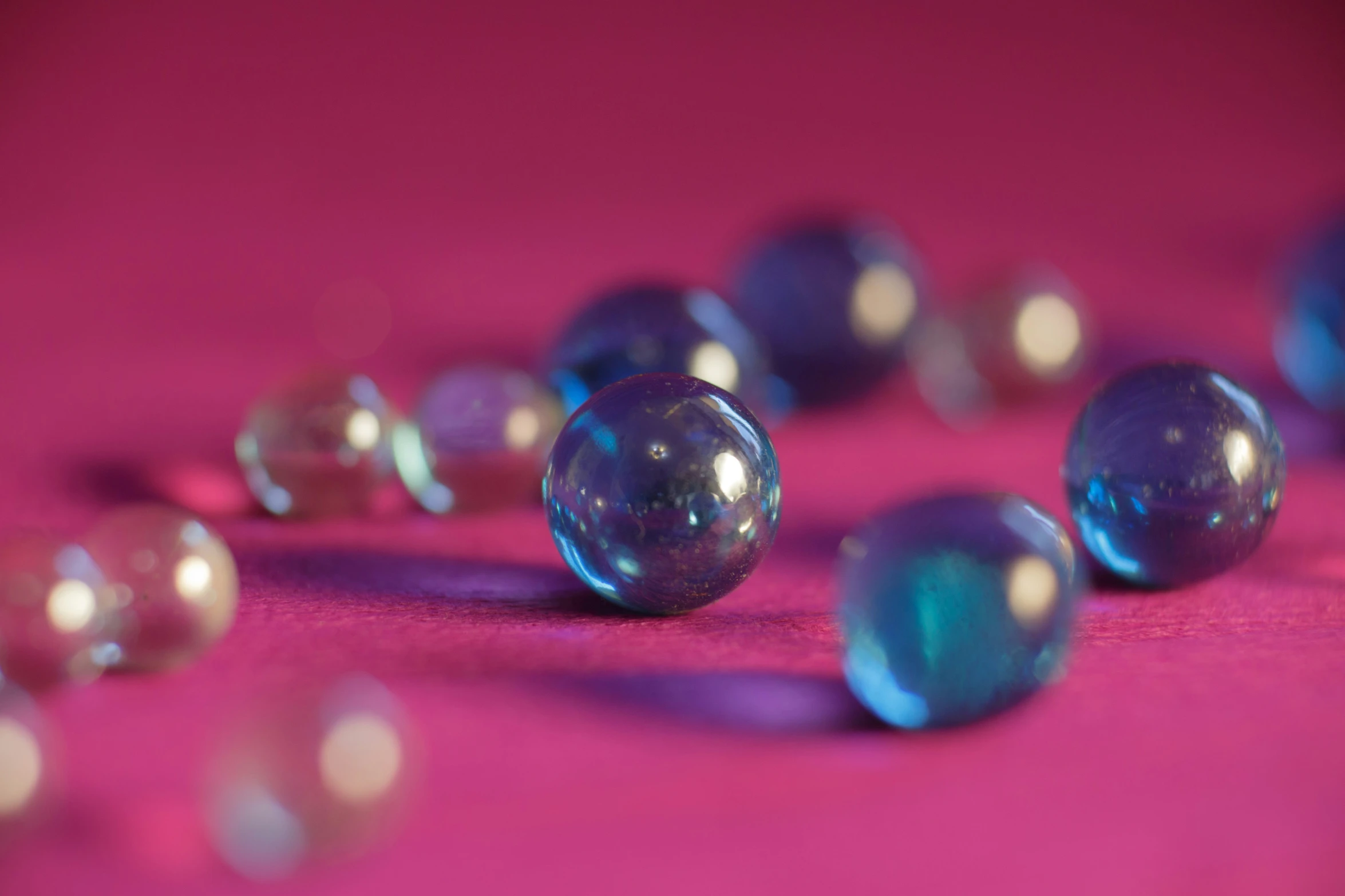 a pink table topped with glass balls