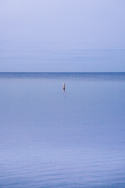 a person in the middle of a large open body of water