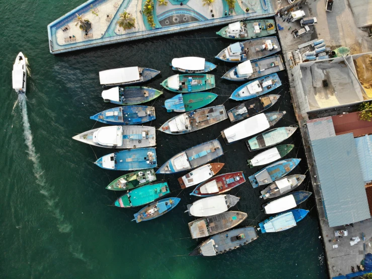 a group of boats parked at a pier on a lake