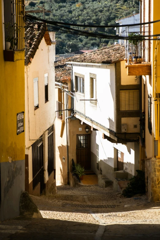 a alley way with a staircase leading to several apartment buildings