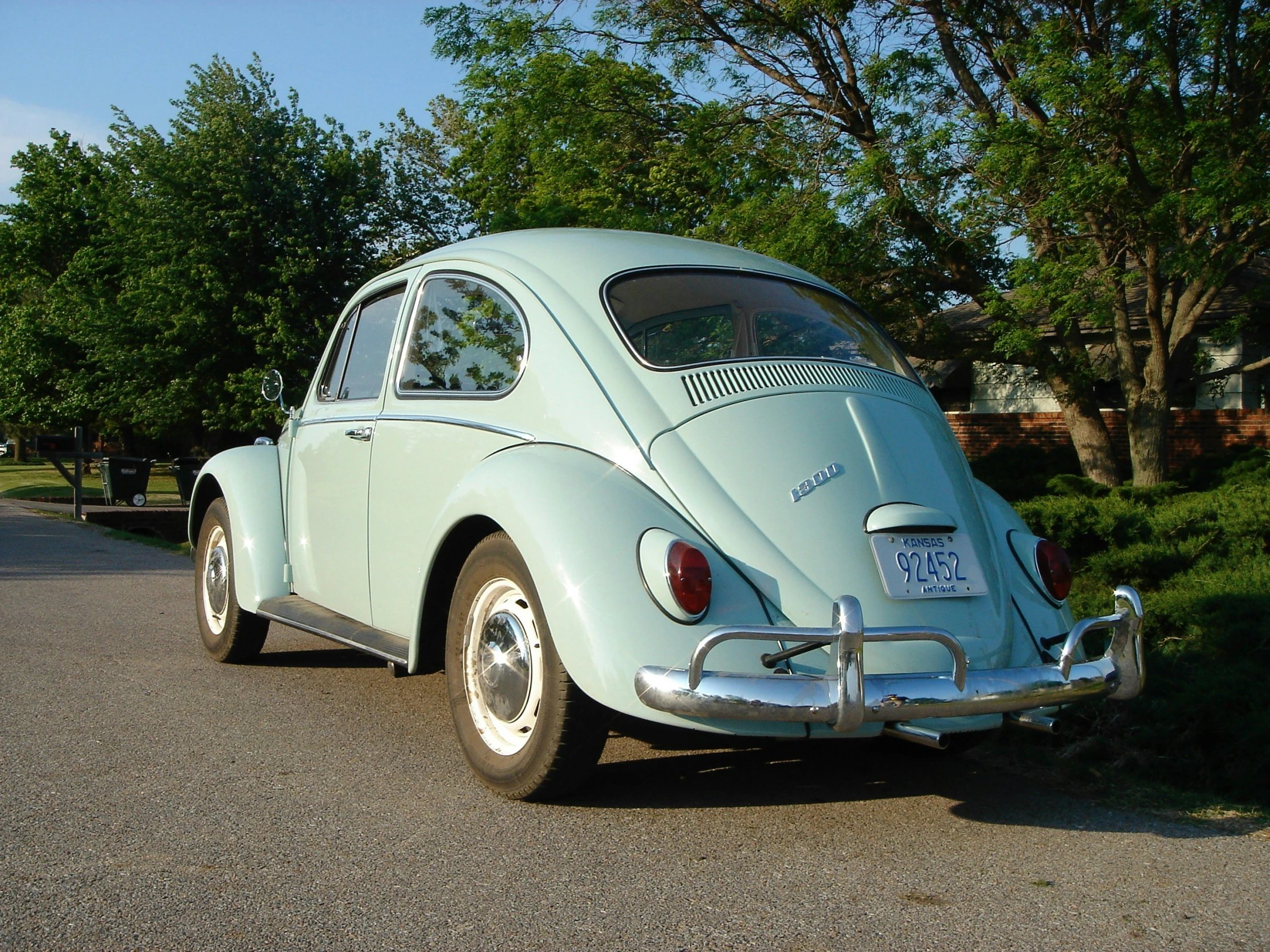 an old beetle car is parked in the street