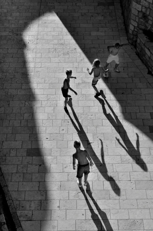 two people, one in cowboy hat and another with a skateboard, shadow on the ground