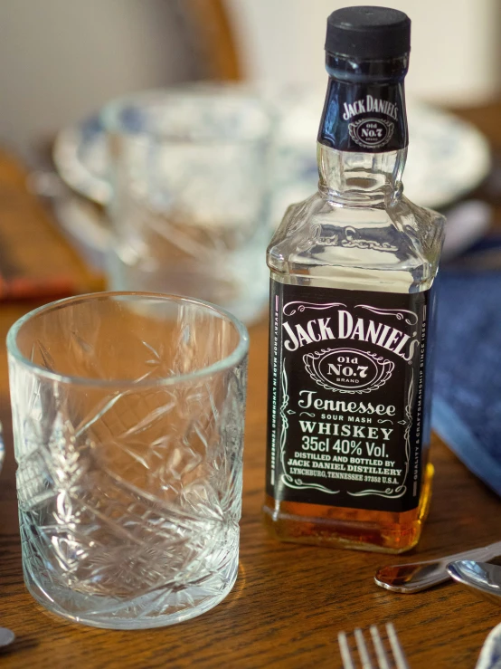 a bottle of jack daniels bourbon next to a glass of whiskey