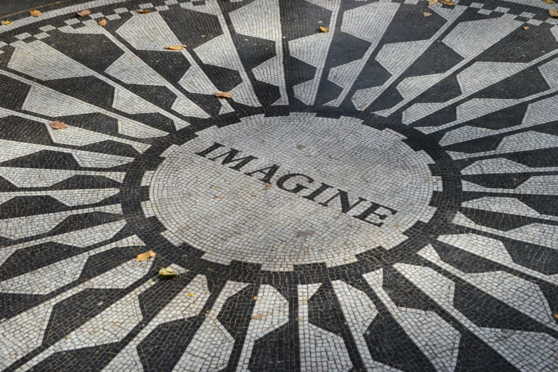 a patterned pavement with the word imagine painted on it