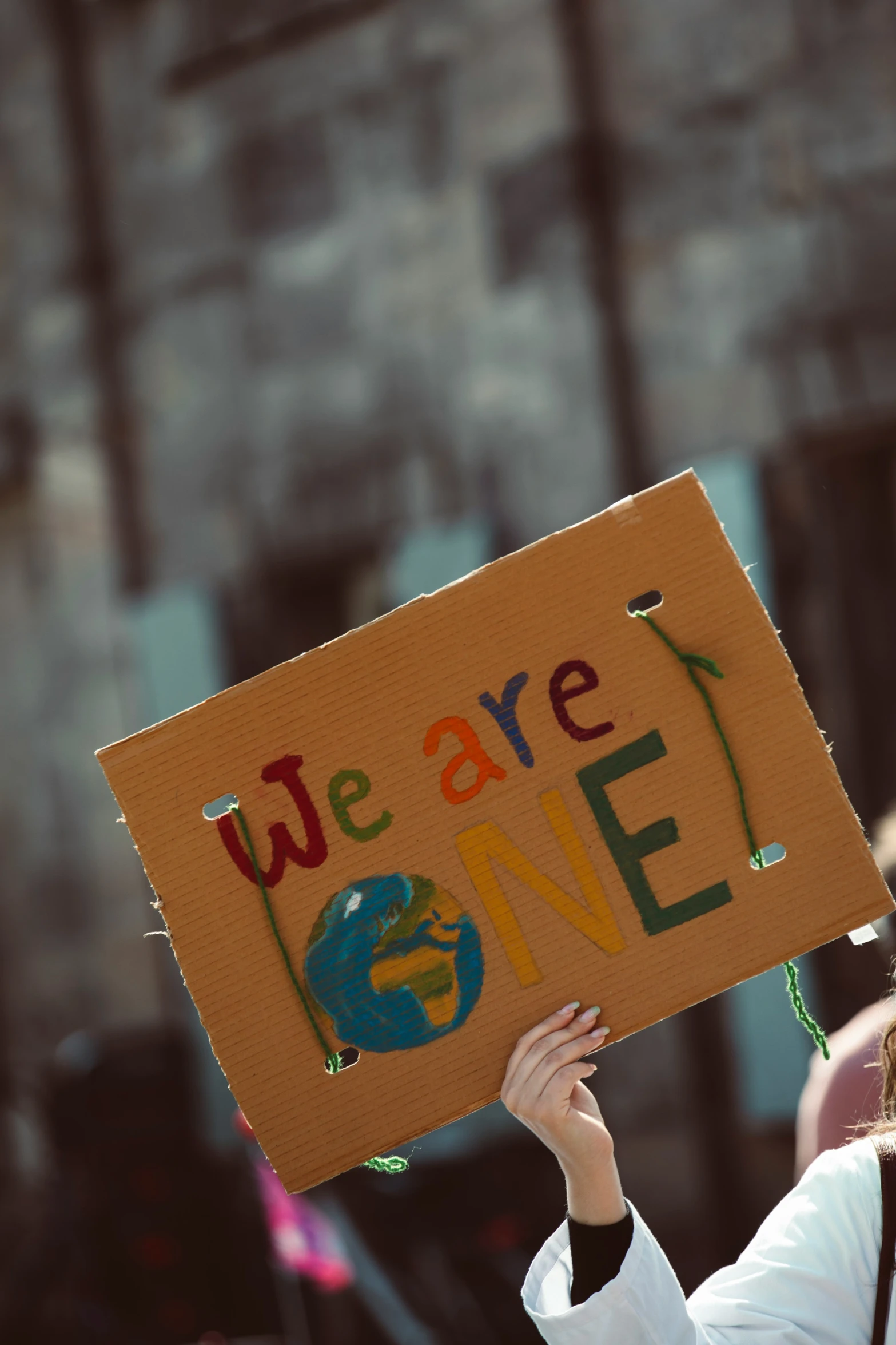 an image of person with protest sign that reads we are done