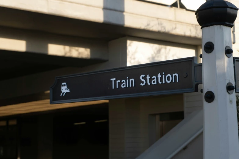 a sign showing the direction to train station