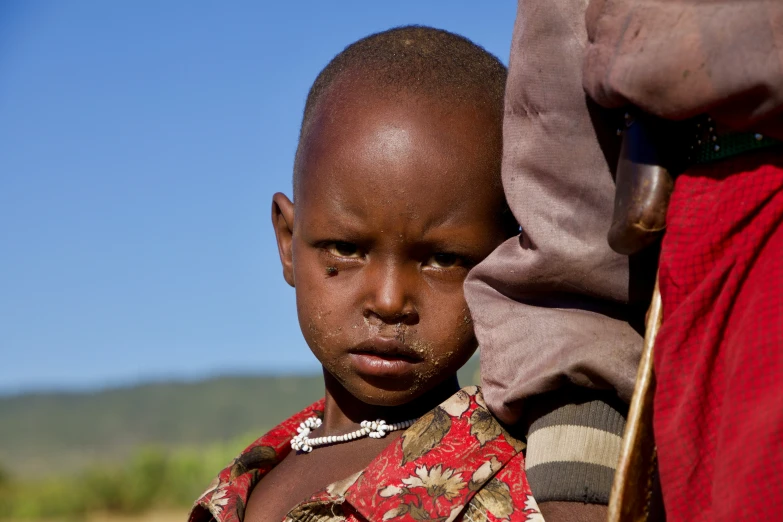 a  with mud on its face standing in front of a woman