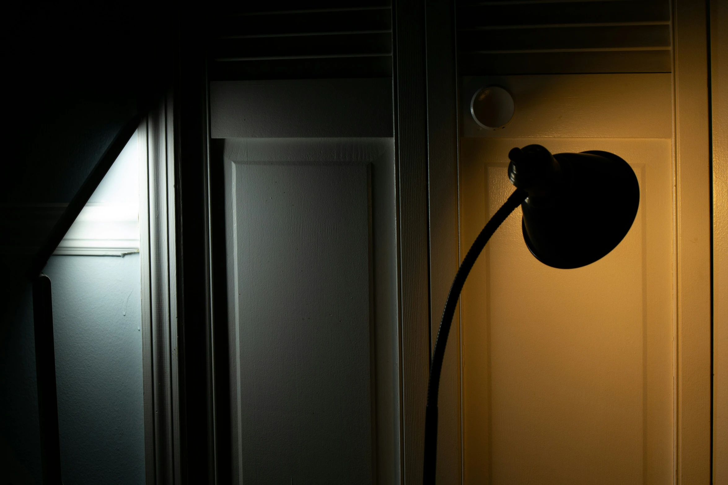 a lamp in a small light with two doorways