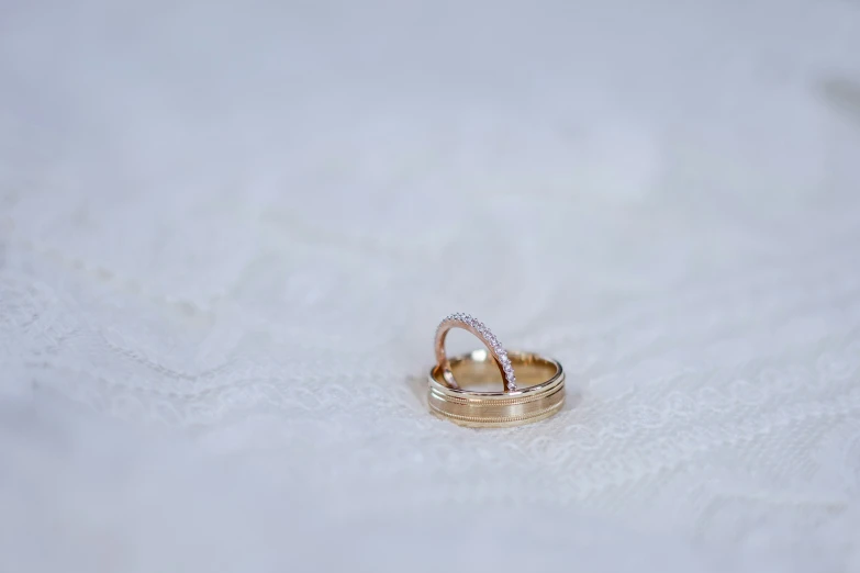 wedding ring, with a pearl inside, resting in a white cloth