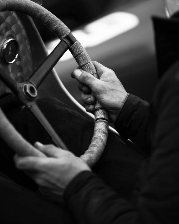 man driving a car on a steering wheel