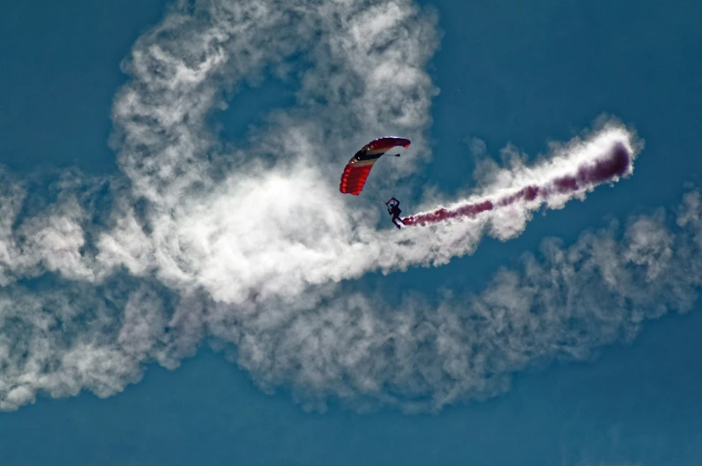 a kite in the air with smoke coming out of it