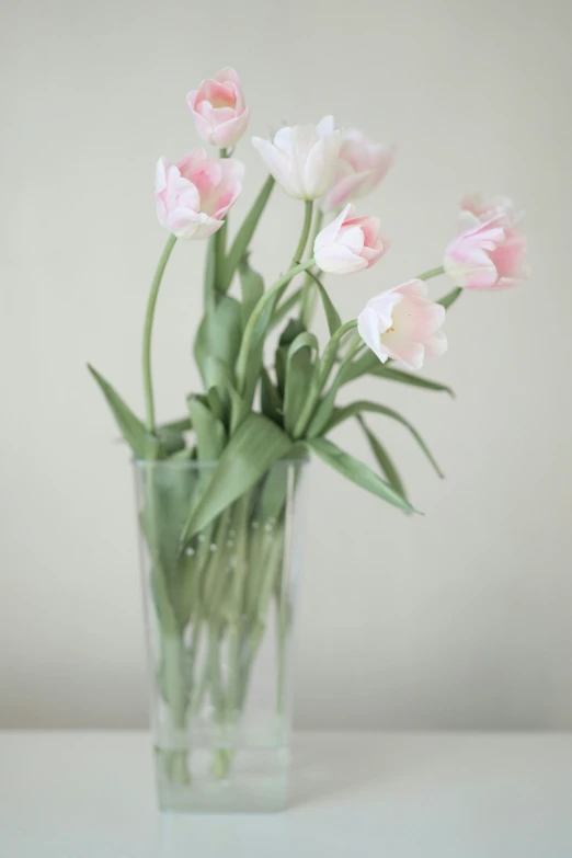 there is a clear vase that has flowers in it