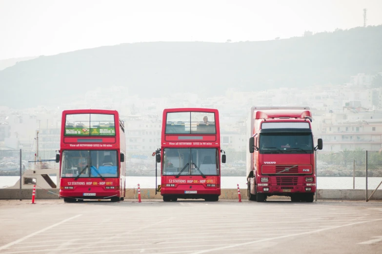 two red double decker buses parked next to each other