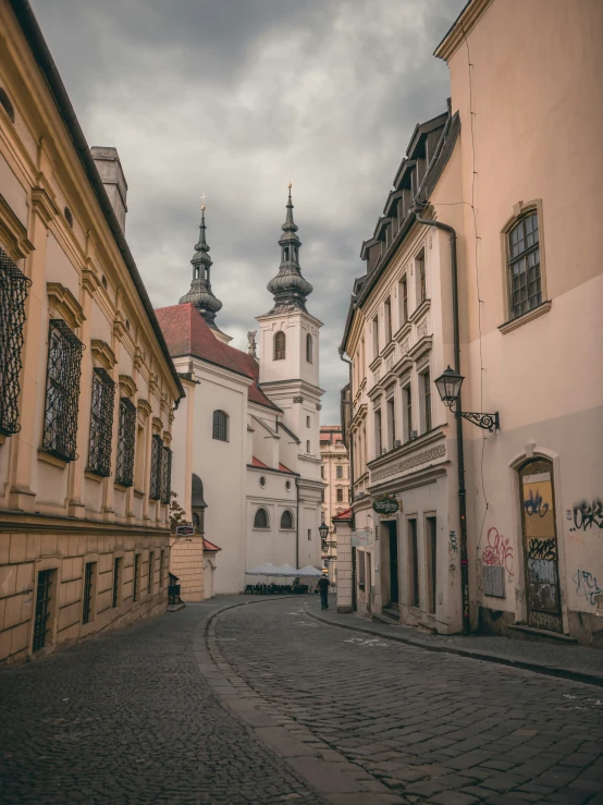 an old street with two buildings and a clock tower