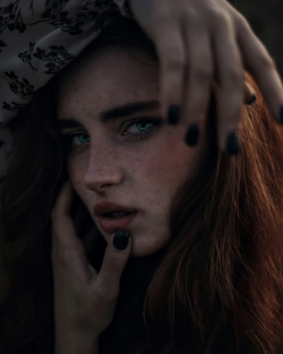 an image of a woman with dark nails posing for a picture