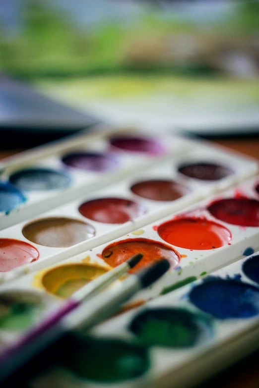 an artistic colorful paint palette, with lots of watercolors