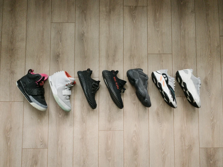 four pairs of shoes lined up in a row on the floor