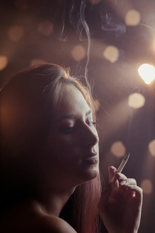 woman smokes a cigarette and stares at the pographer