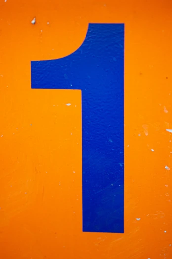 a blue letter on top of an orange background