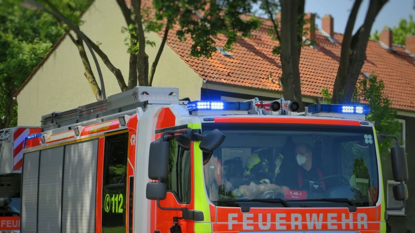 a fire truck with an emergency team is parked outside