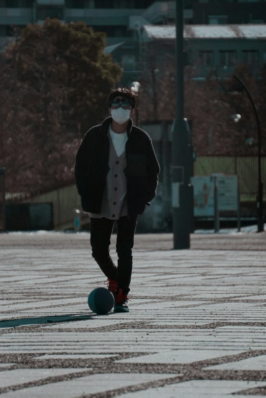 a man wearing a face mask while playing soccer