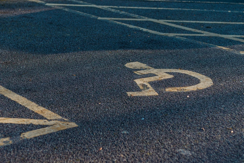 a close - up of a handicap sign on the pavement