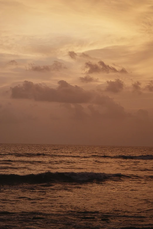 a large body of water surrounded by cloudy skies