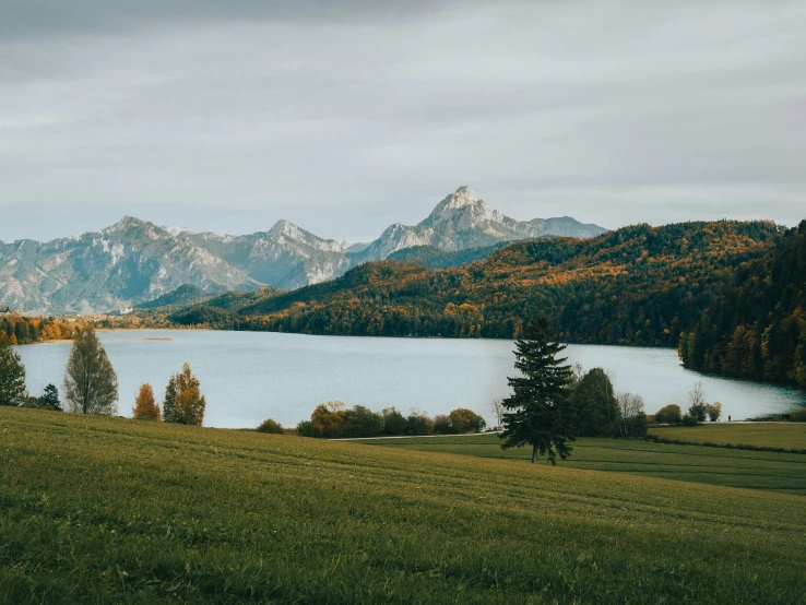 a blue lake with mountains on either side